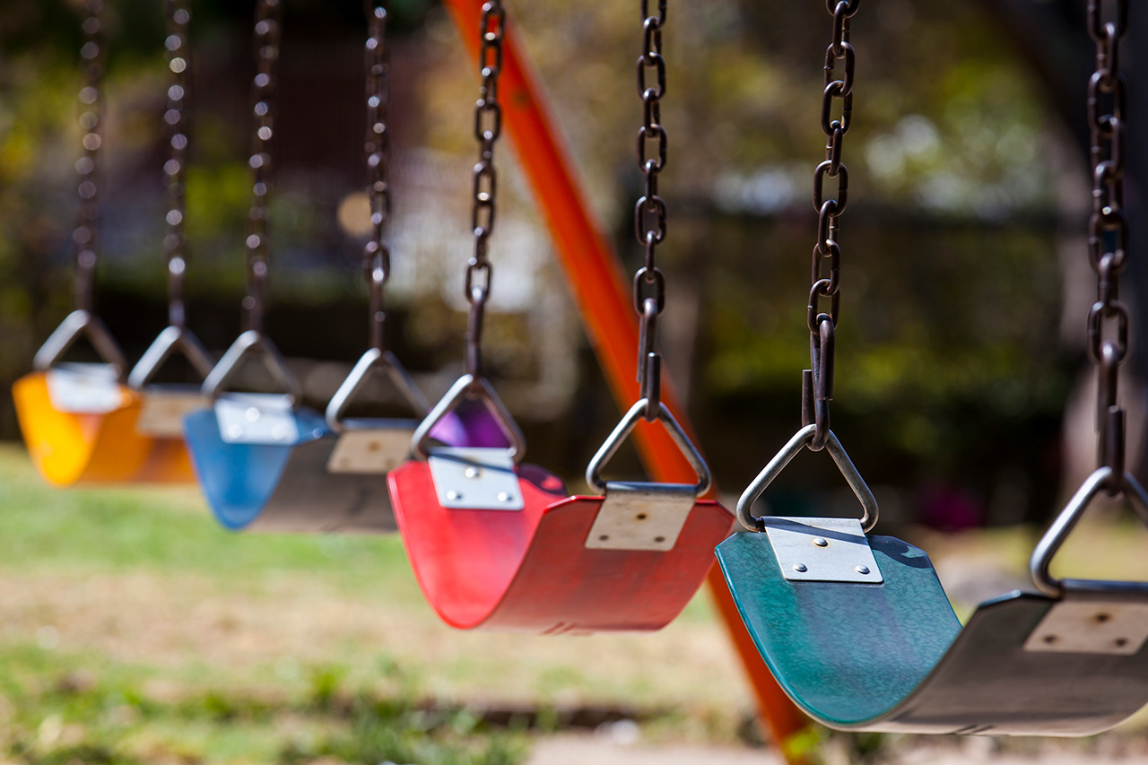 empty colorful swings at the park